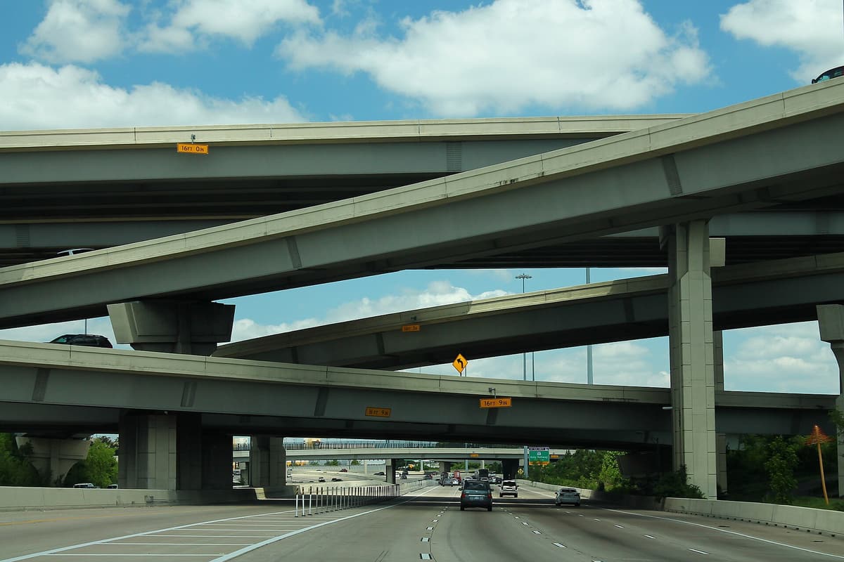 Several levels of concrete flyover ramps crossing above westbound Interstate 10 at its interchange with Interstate 610